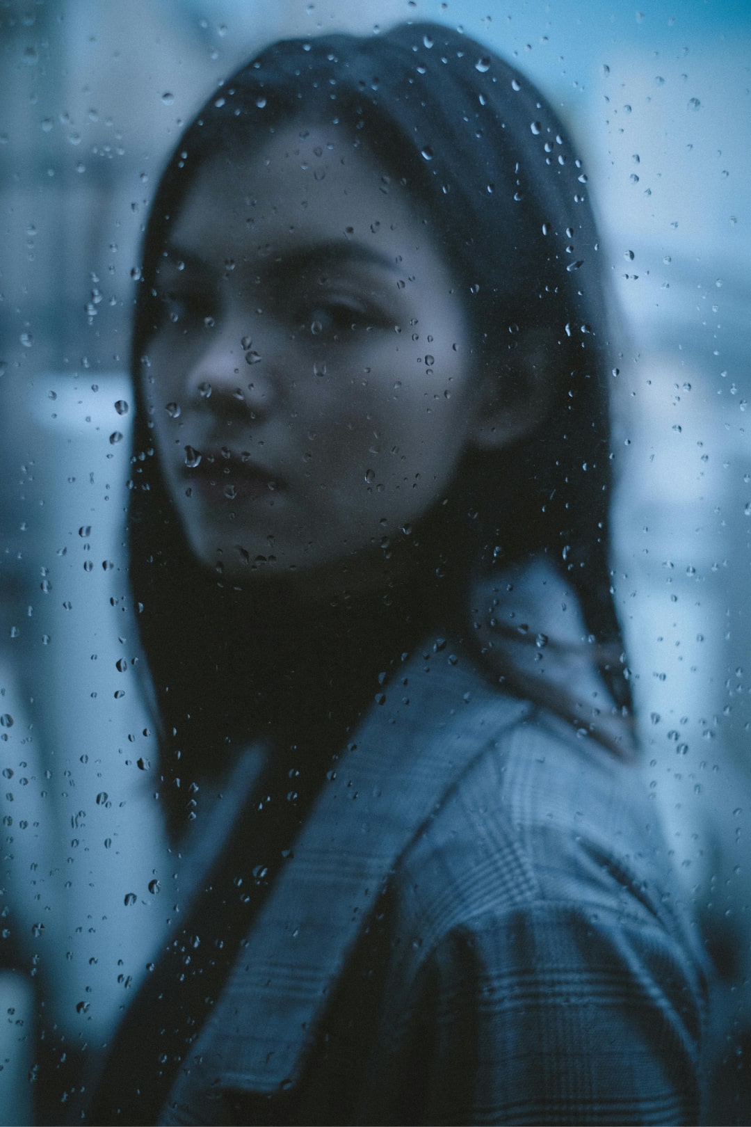 the girl behind the rainy window