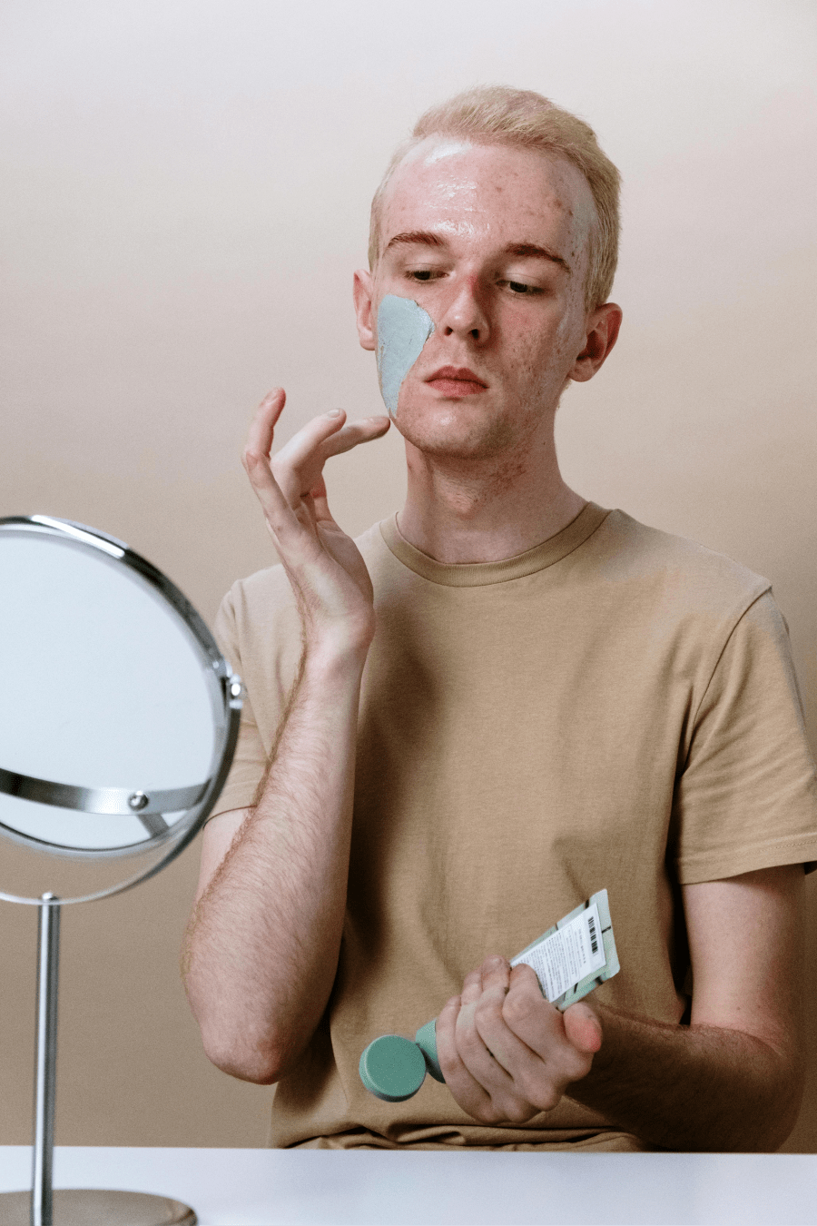 a man looking at himself in a mirror | National Social Anxiety Center