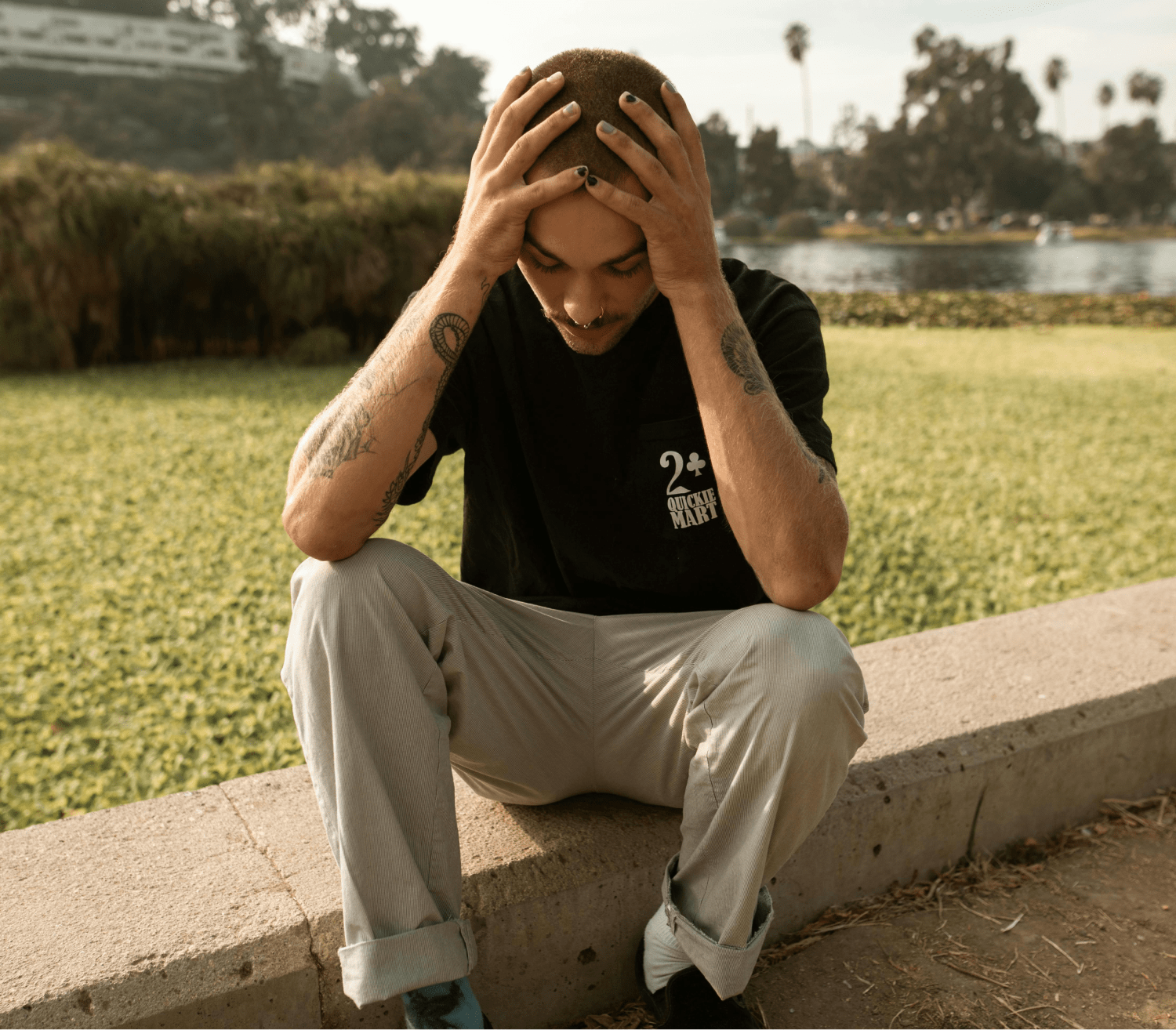 man sitting with both hands on his head