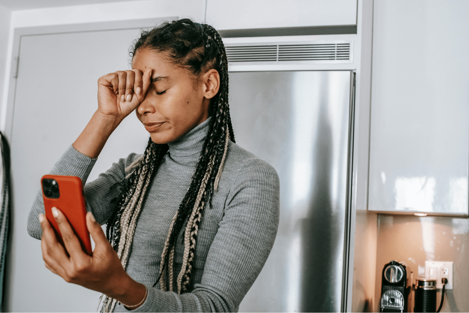 Black woman looking at her phone