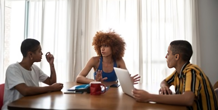 The 3 people seated at a table