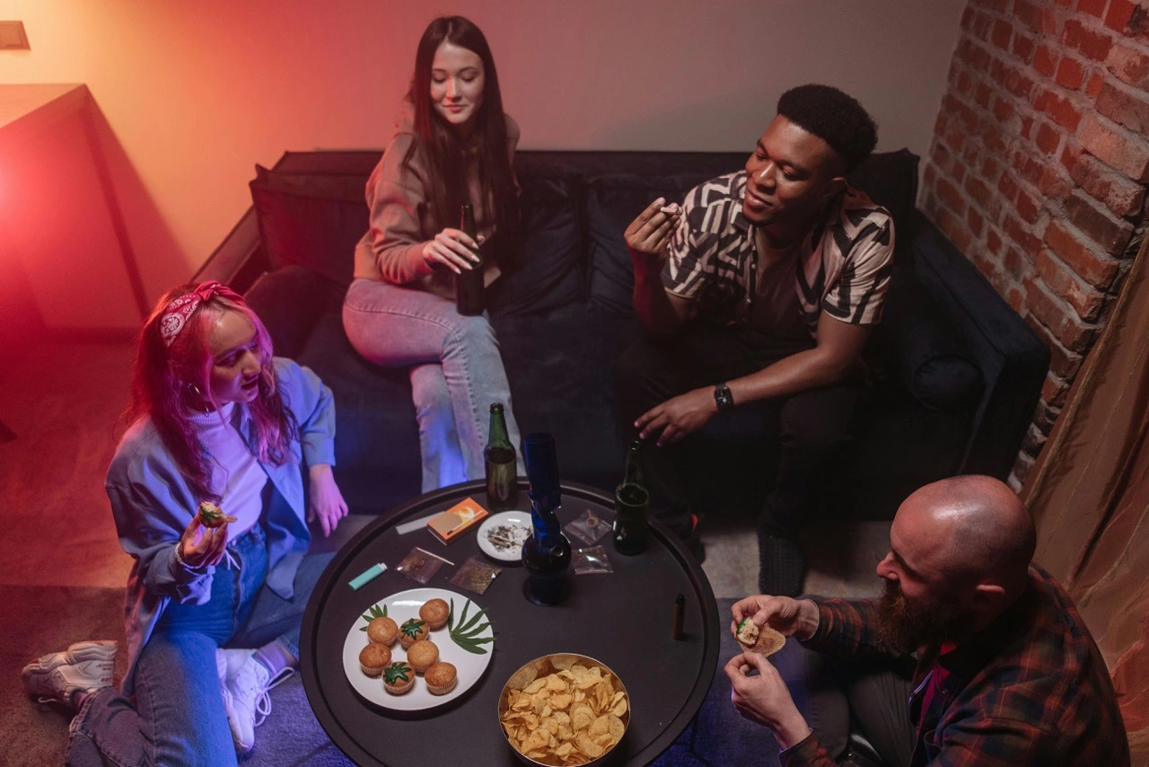 the photo of the 4 people chatting and eating