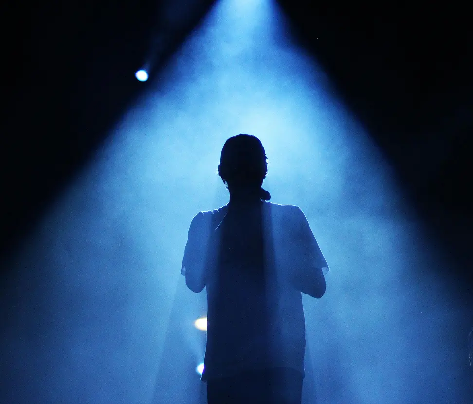 photo of the person standing in the spotlight
