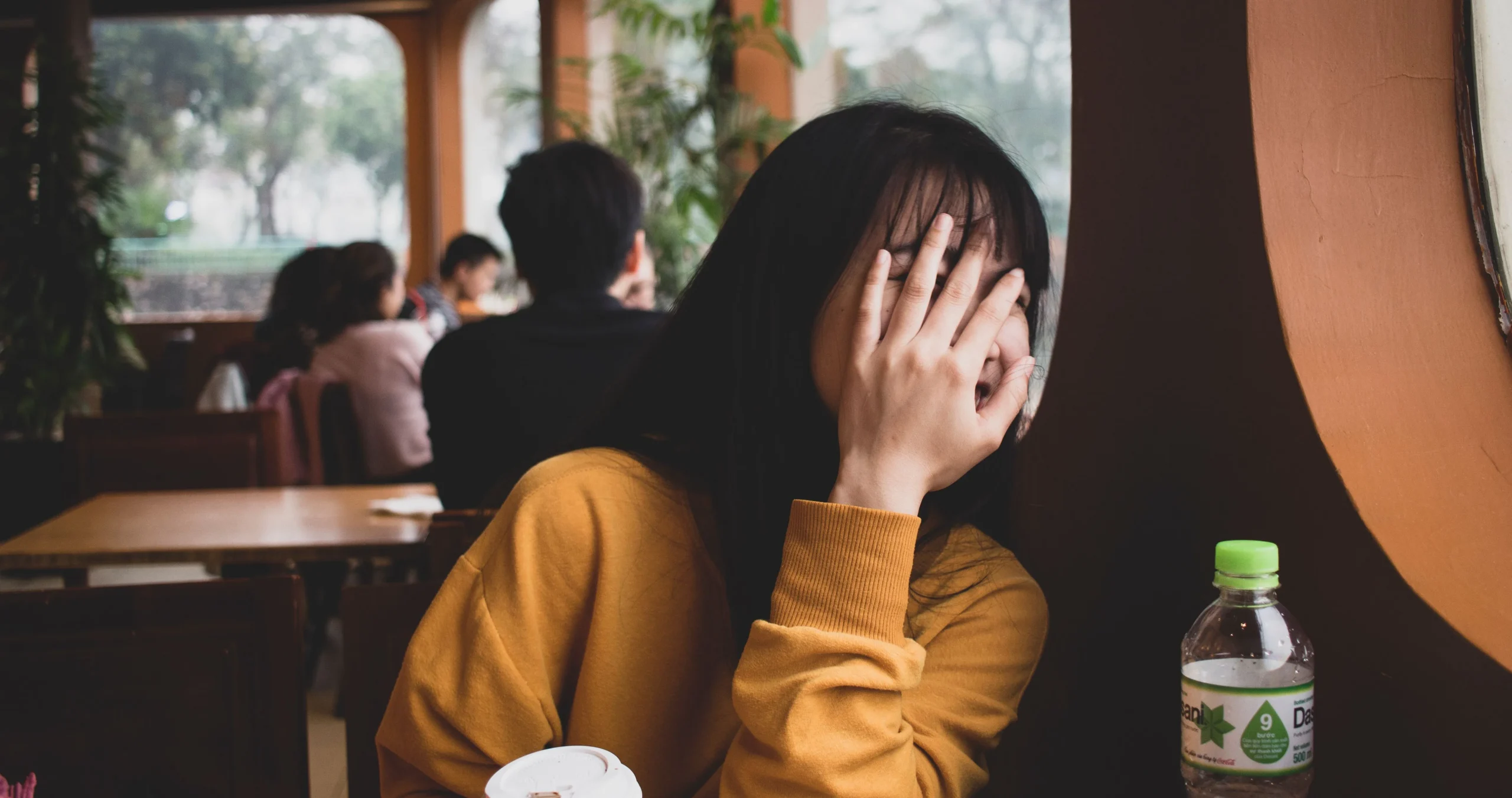 the photo of the woman with her hand covering her face